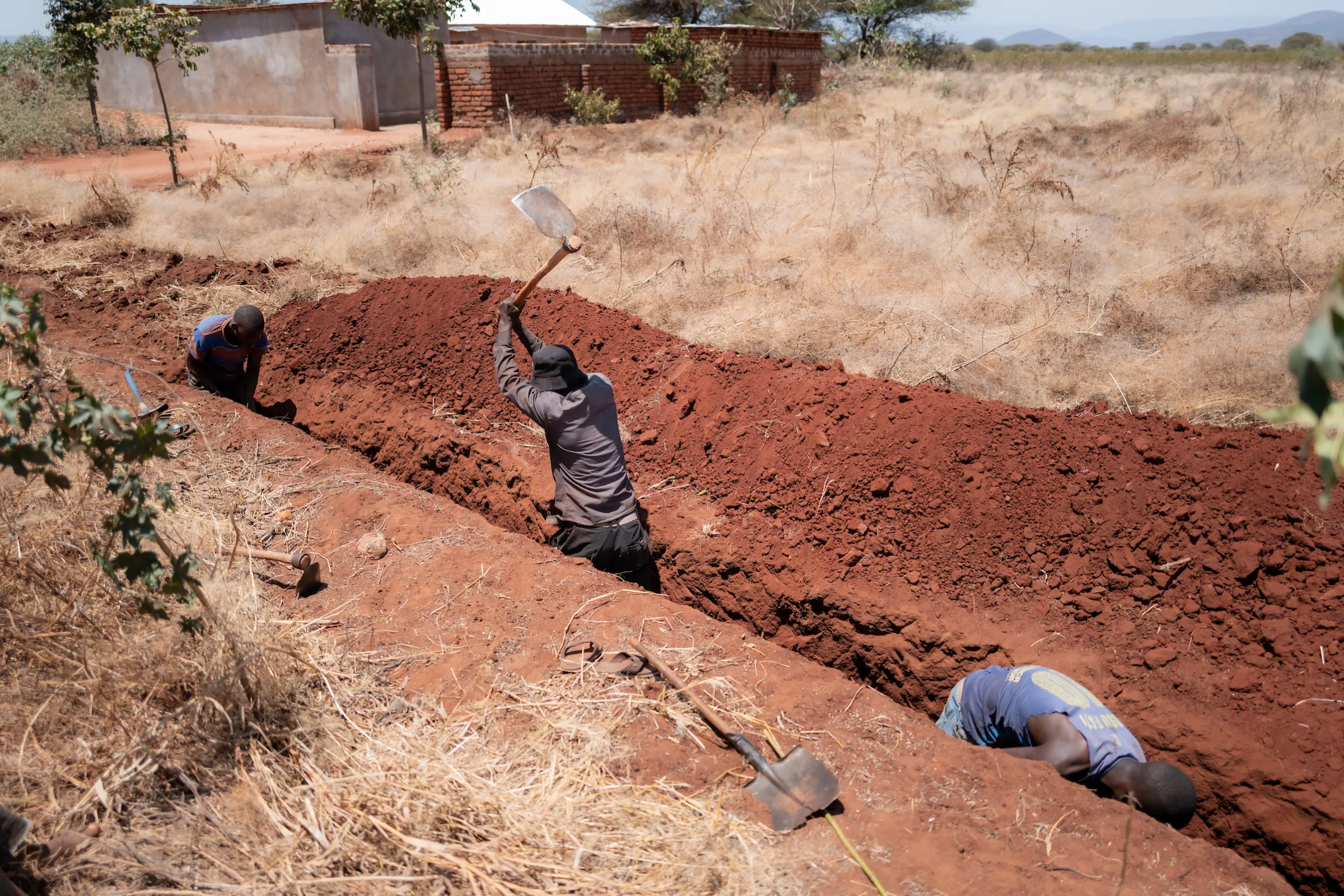 Men digging a trench in Africa