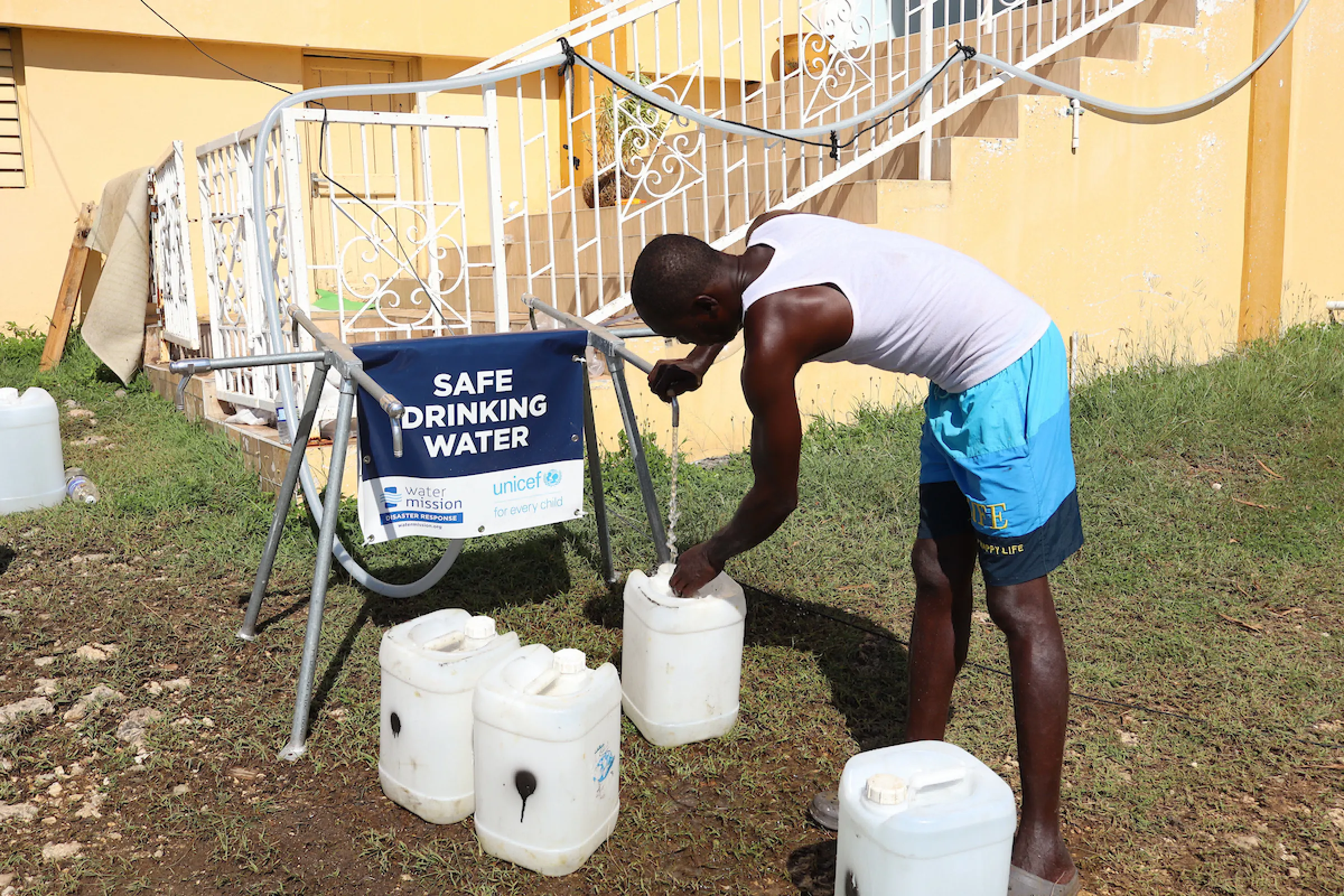 A Jamaican man accesses safe drinking water