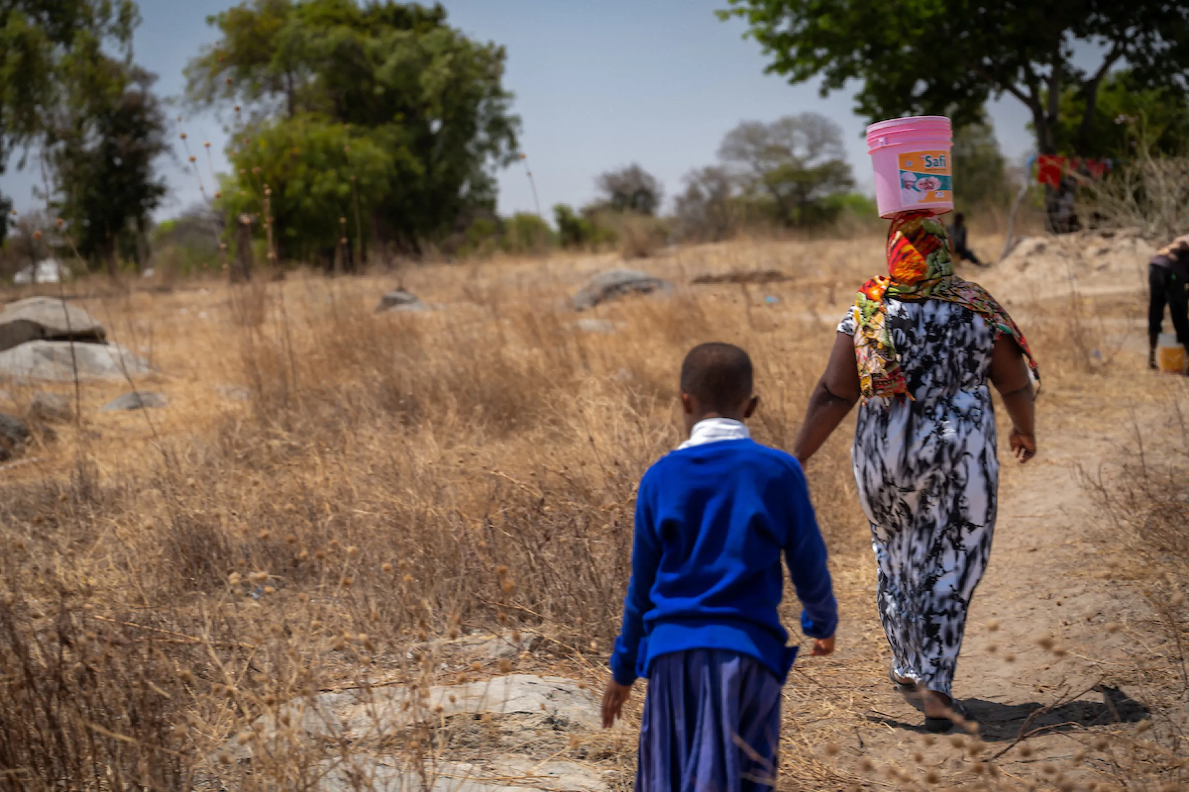 Pendo and daughter walking for water