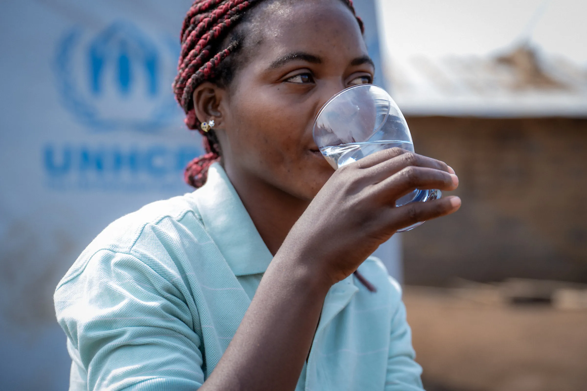 Katembo sips safe water; Nyarugusu Refugee Camp; Tanzania, Africa