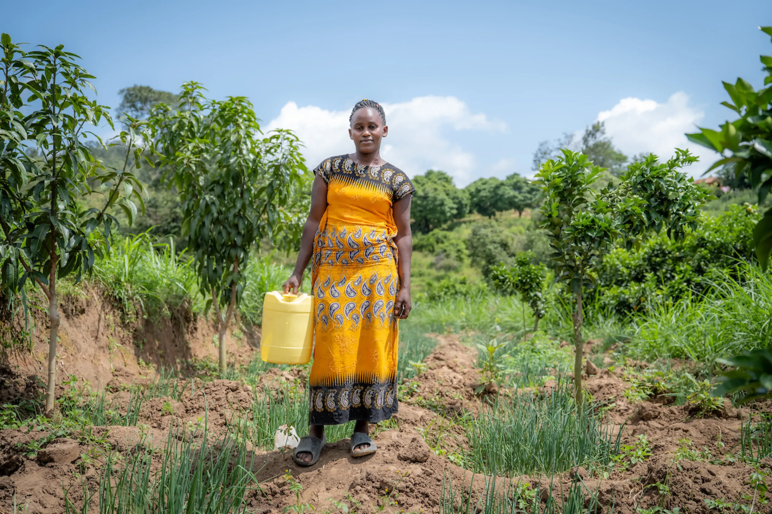 Elizabeth standing with a bucket