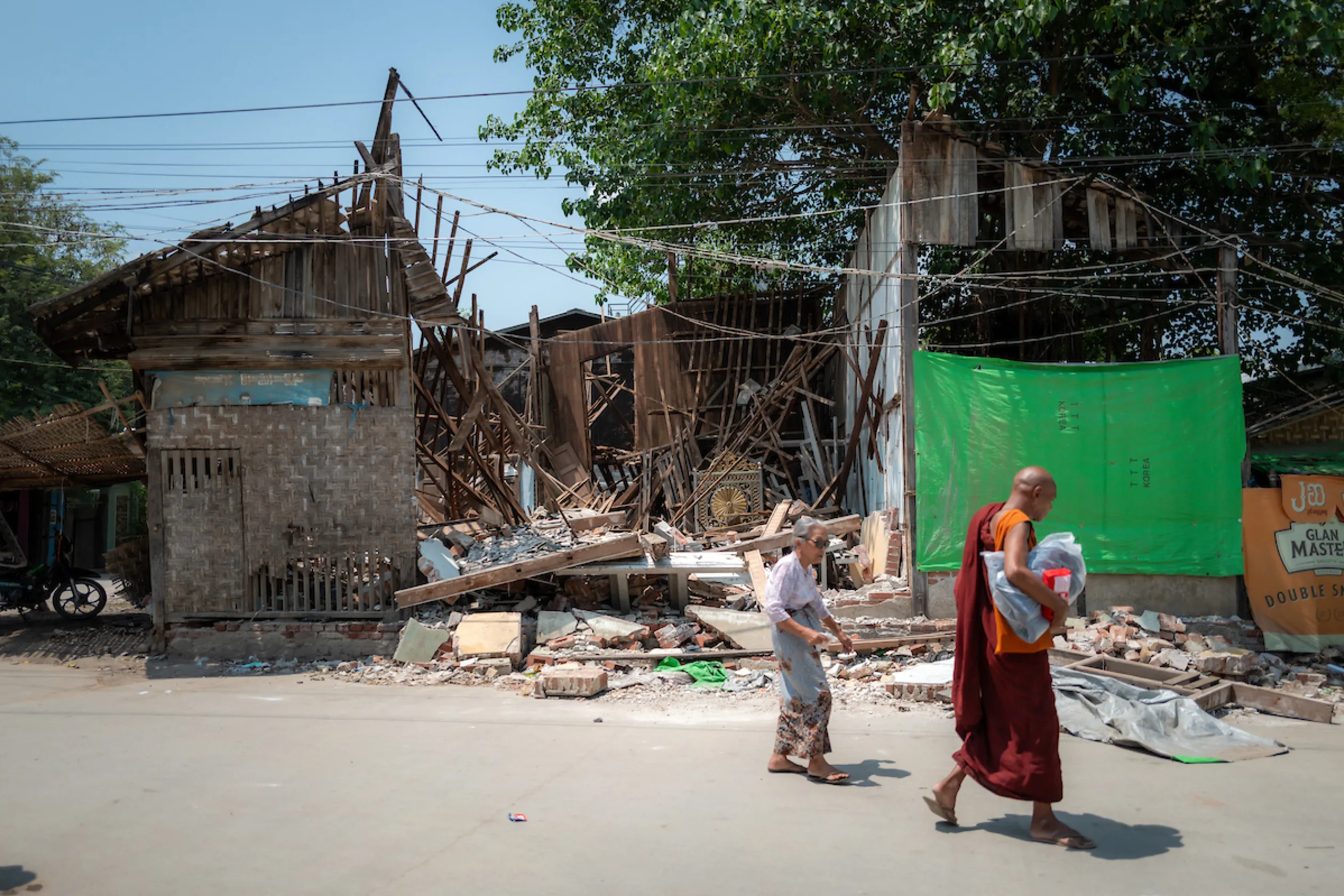People walk amidst destruction