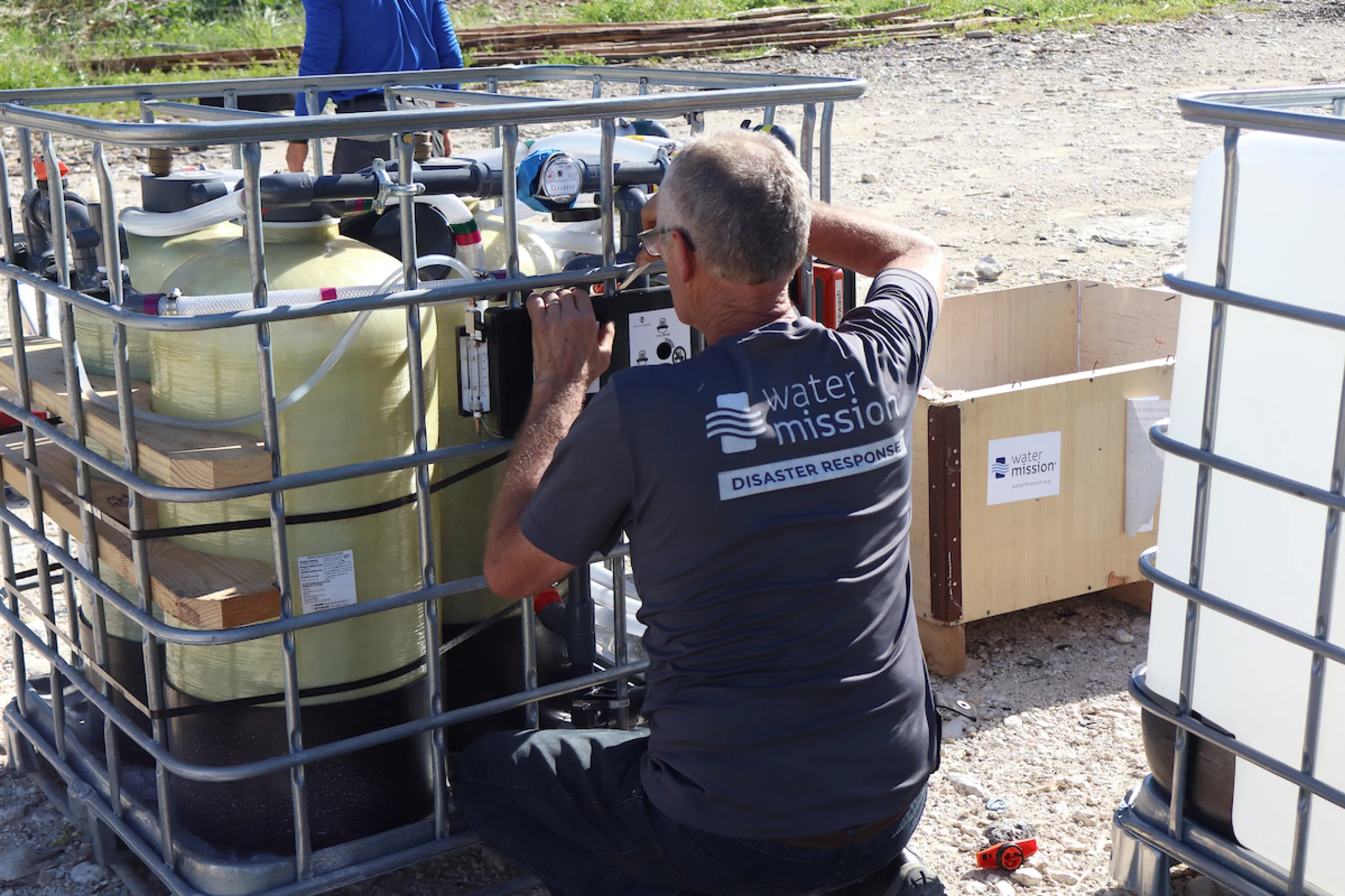 A Water Mission DART member installs a safe water system