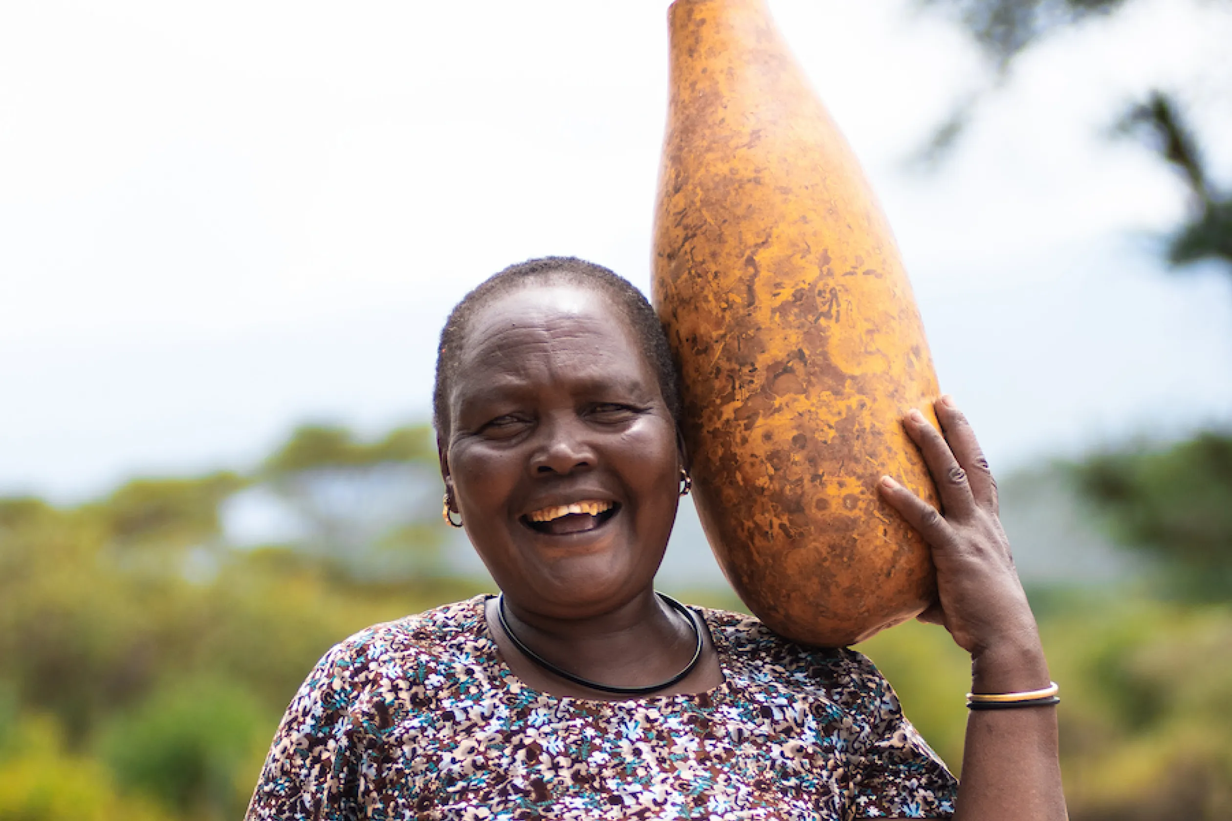 African woman carries can of water