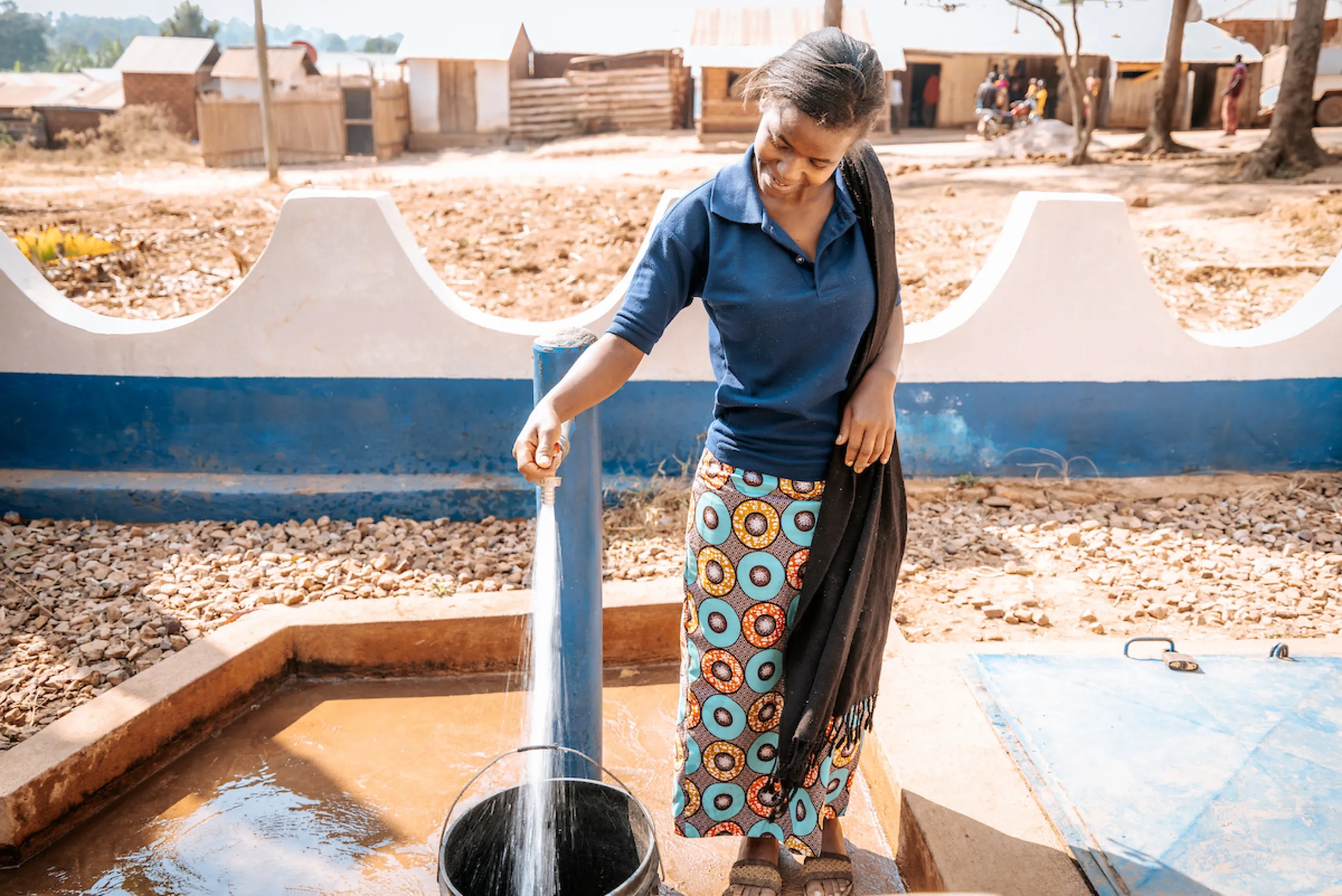 Jackline filling up her bucket with safe, clean water