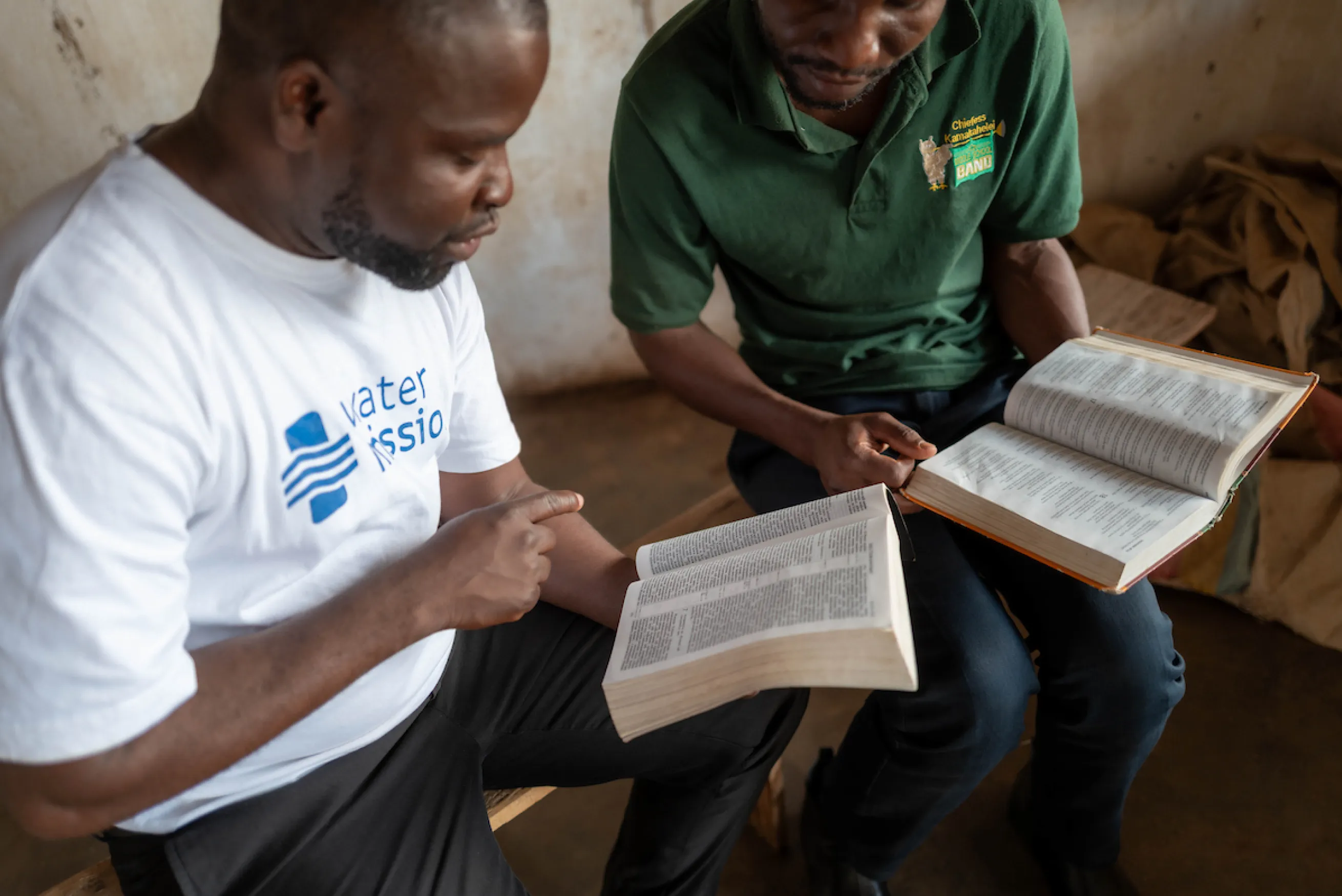 Pastor Brave reading the Bible with a student