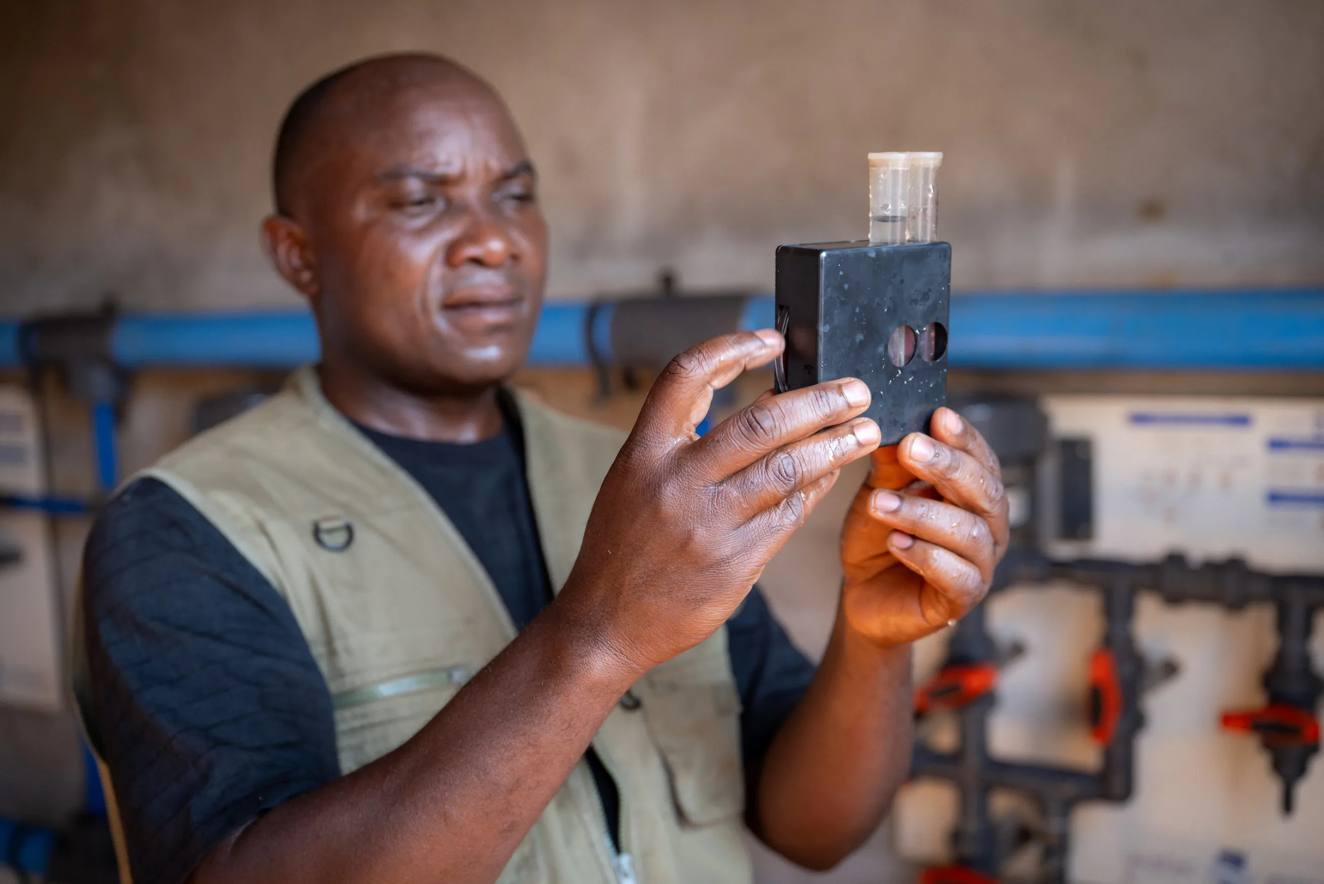 Man testing chlorine levels in Nyarugusu Tanzania