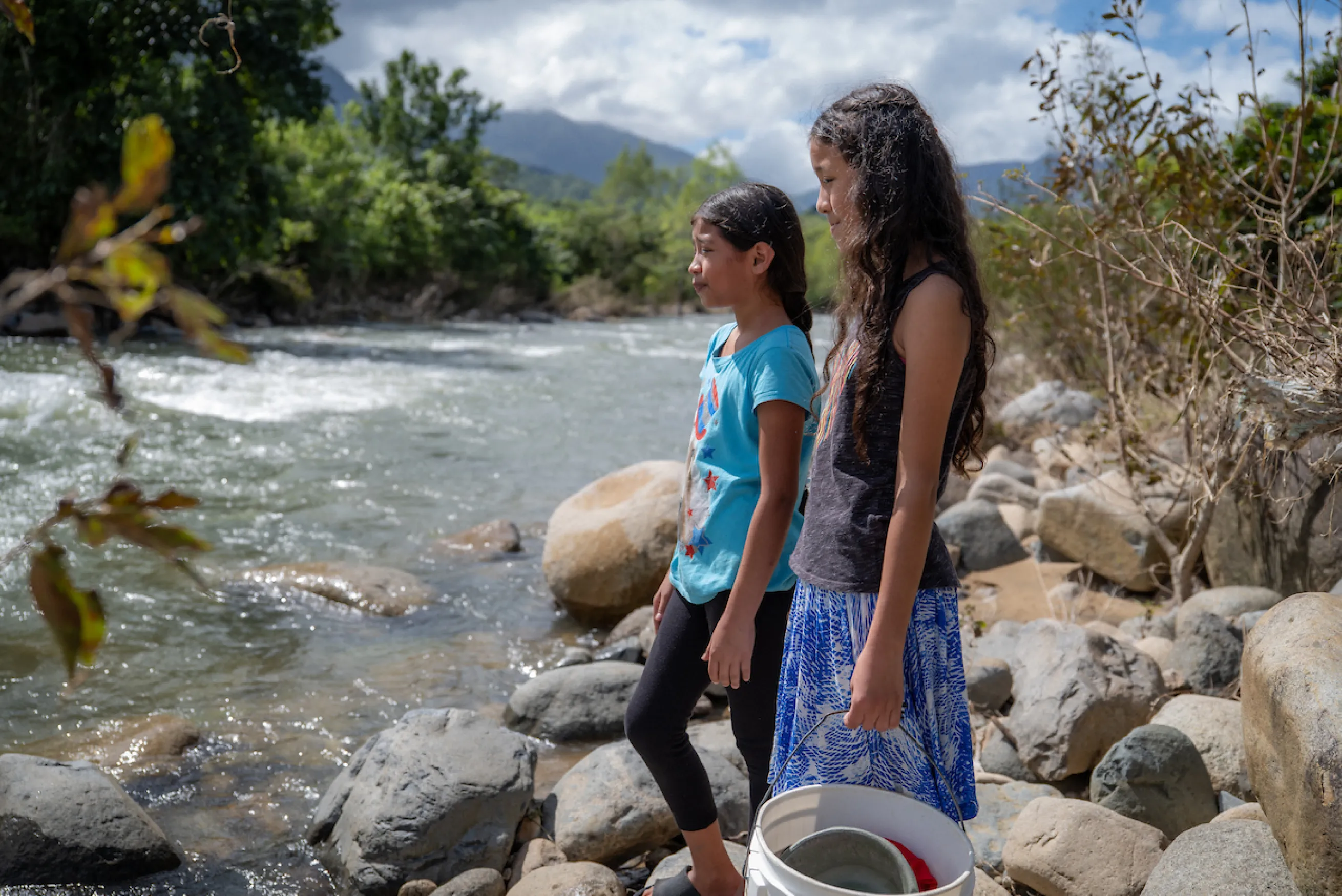 Two Honduran girls looking at a river