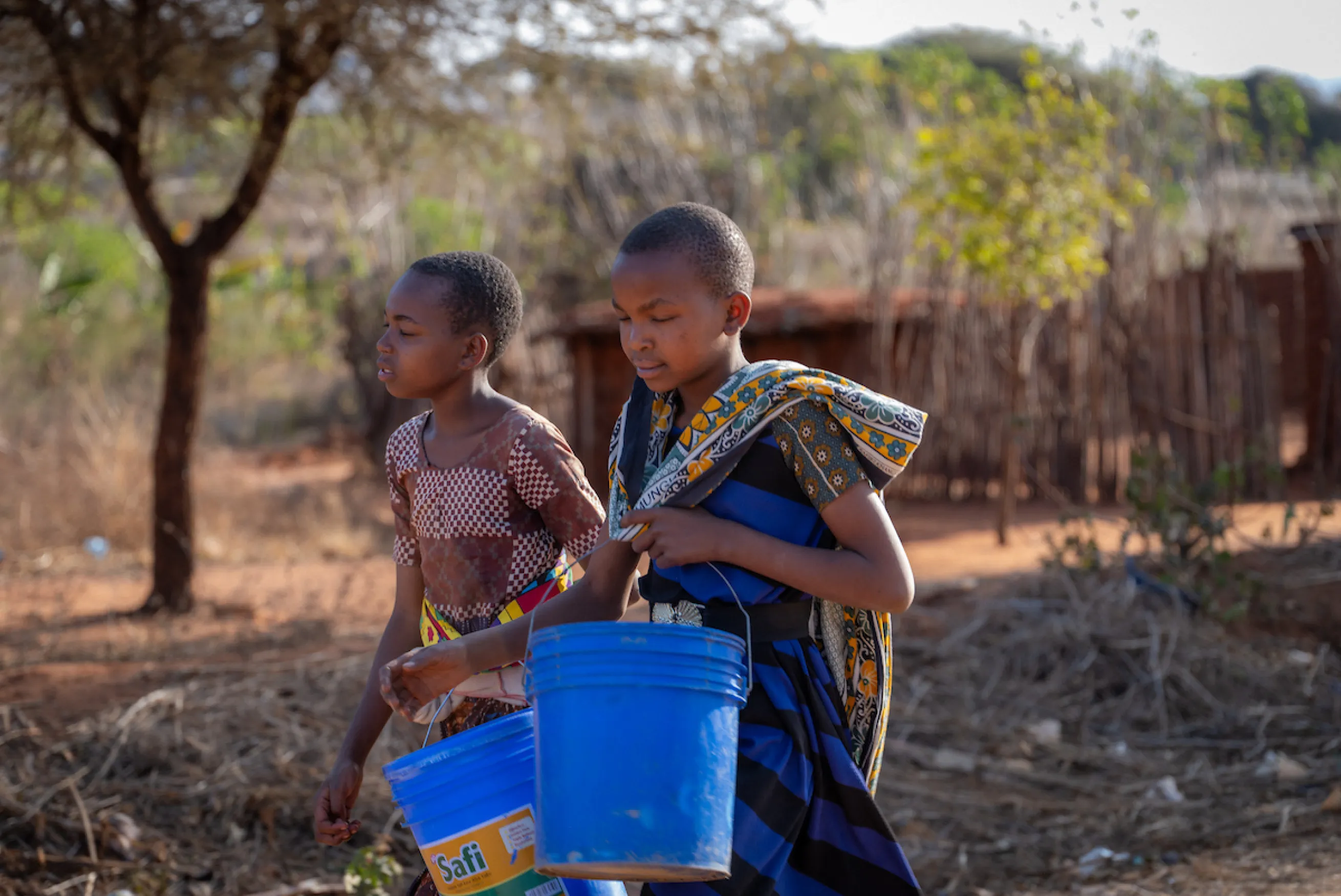 Neema and her friend walk for water