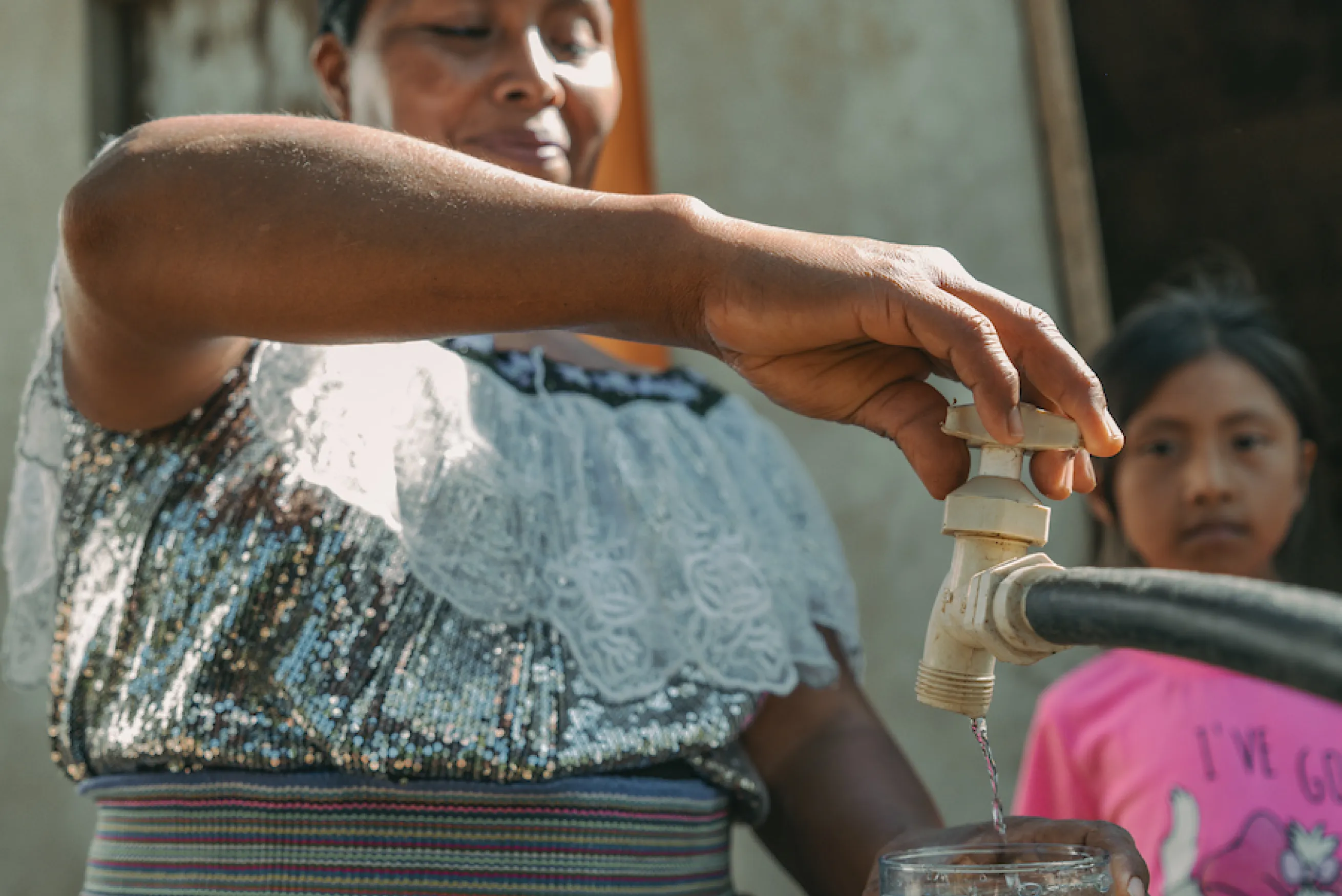 A woman from Mexico at a water tap