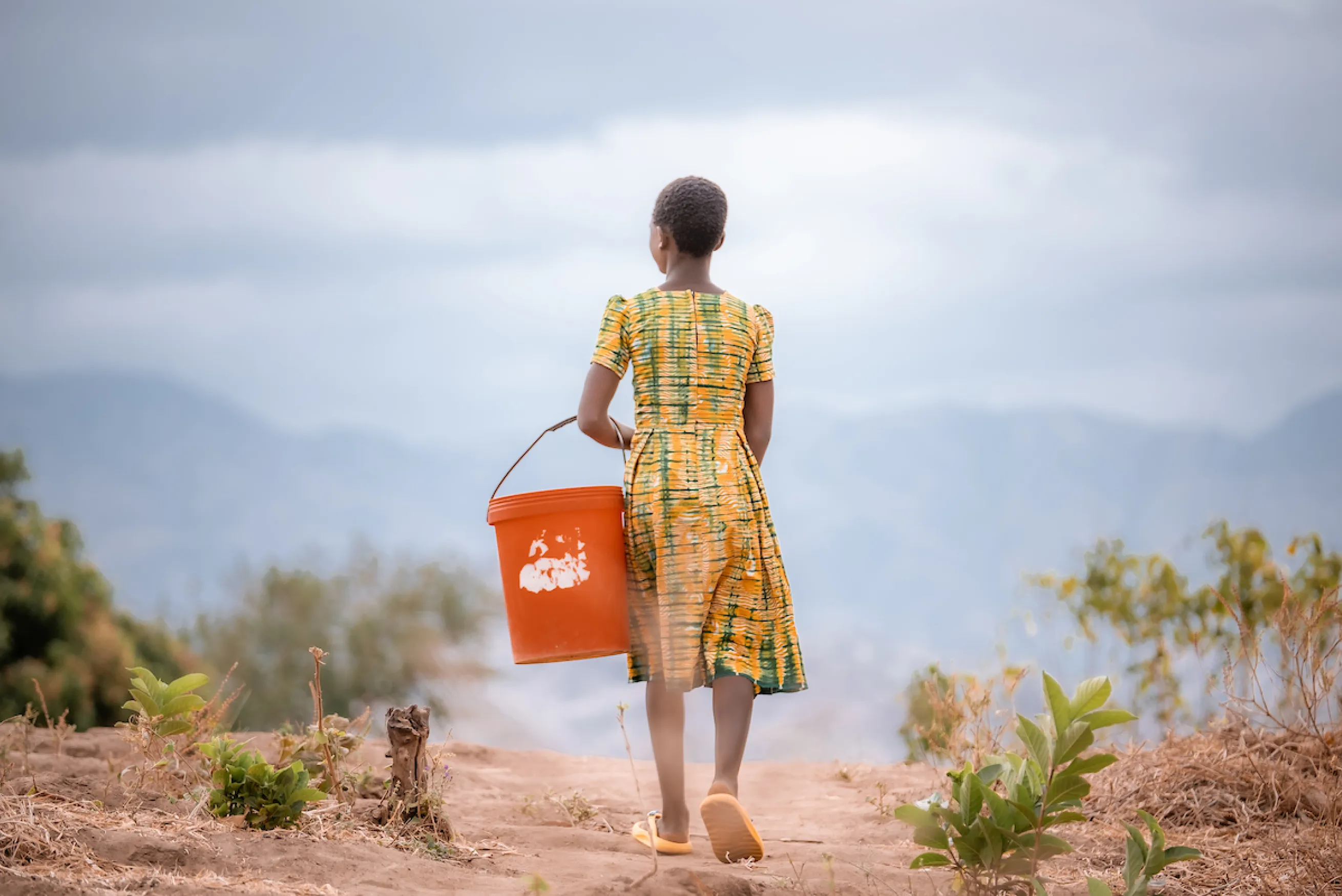Gladys walking for water in Malawi