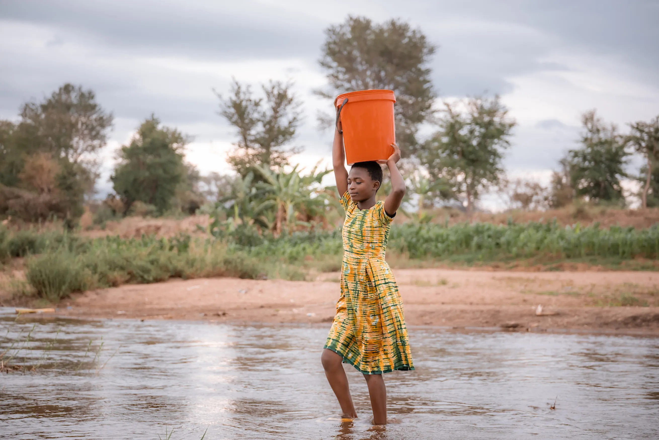 Gladys walking for water in Malawi