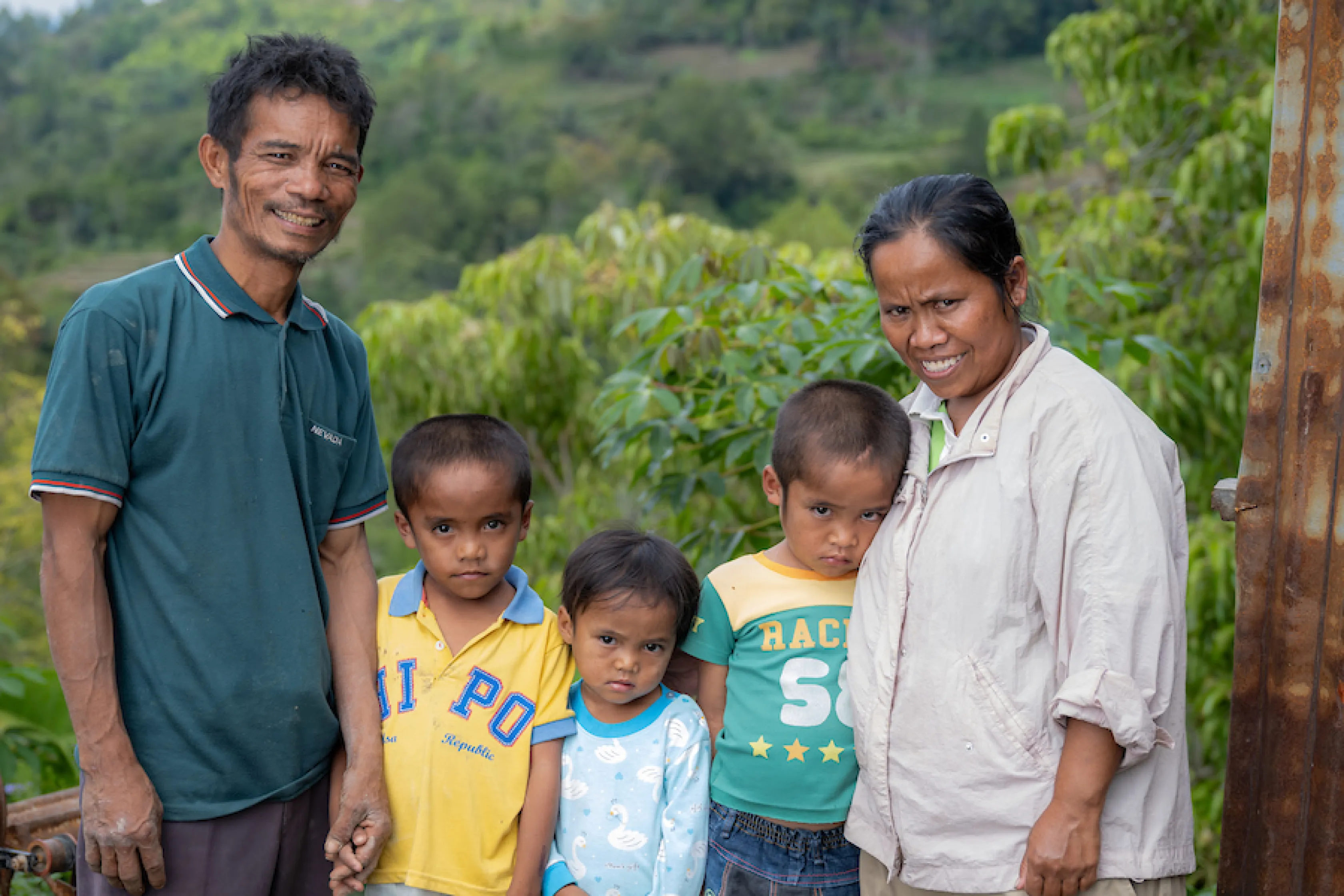 A family of five poses for a photo