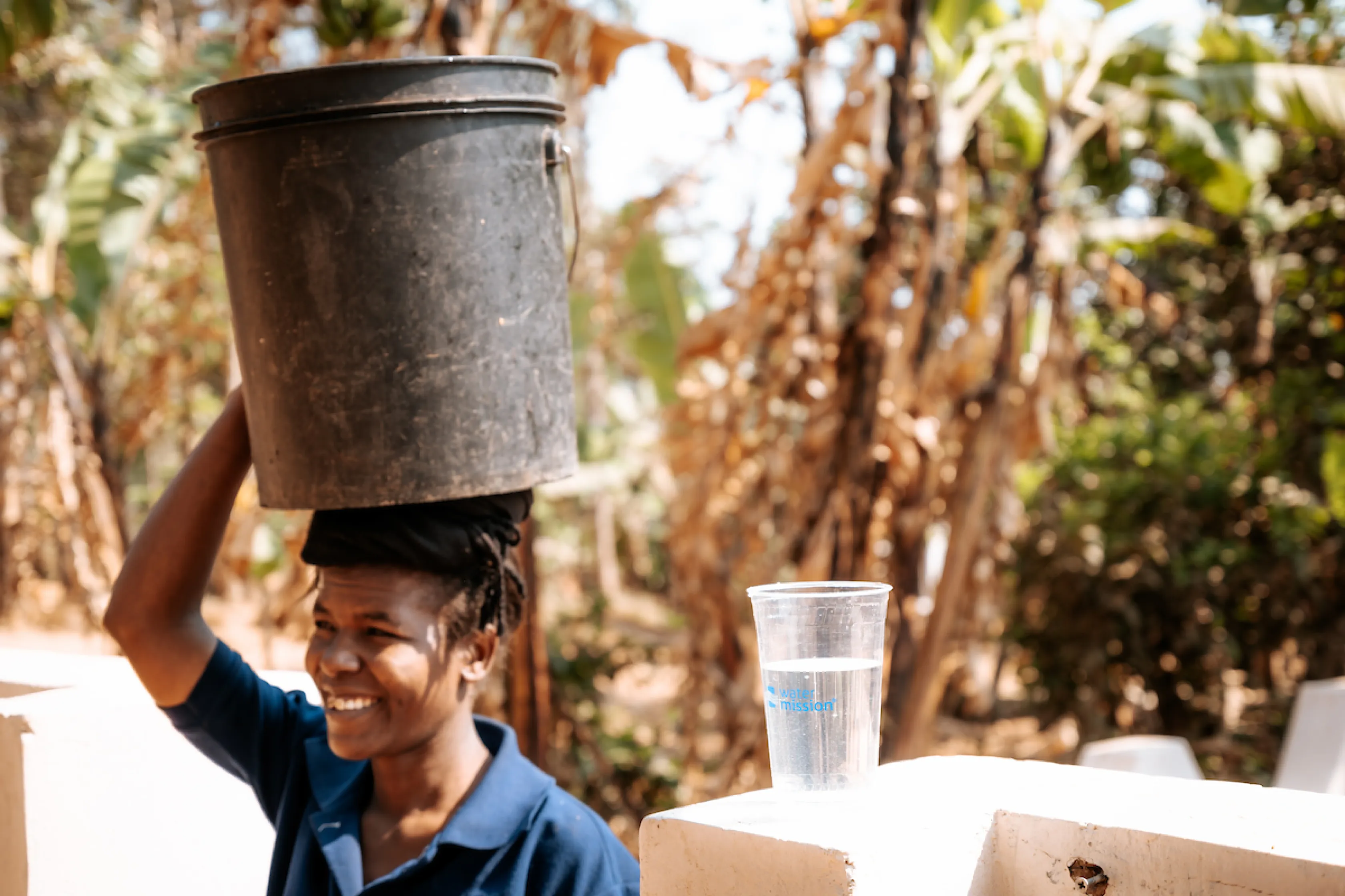 Jackline with bucket of water on her head