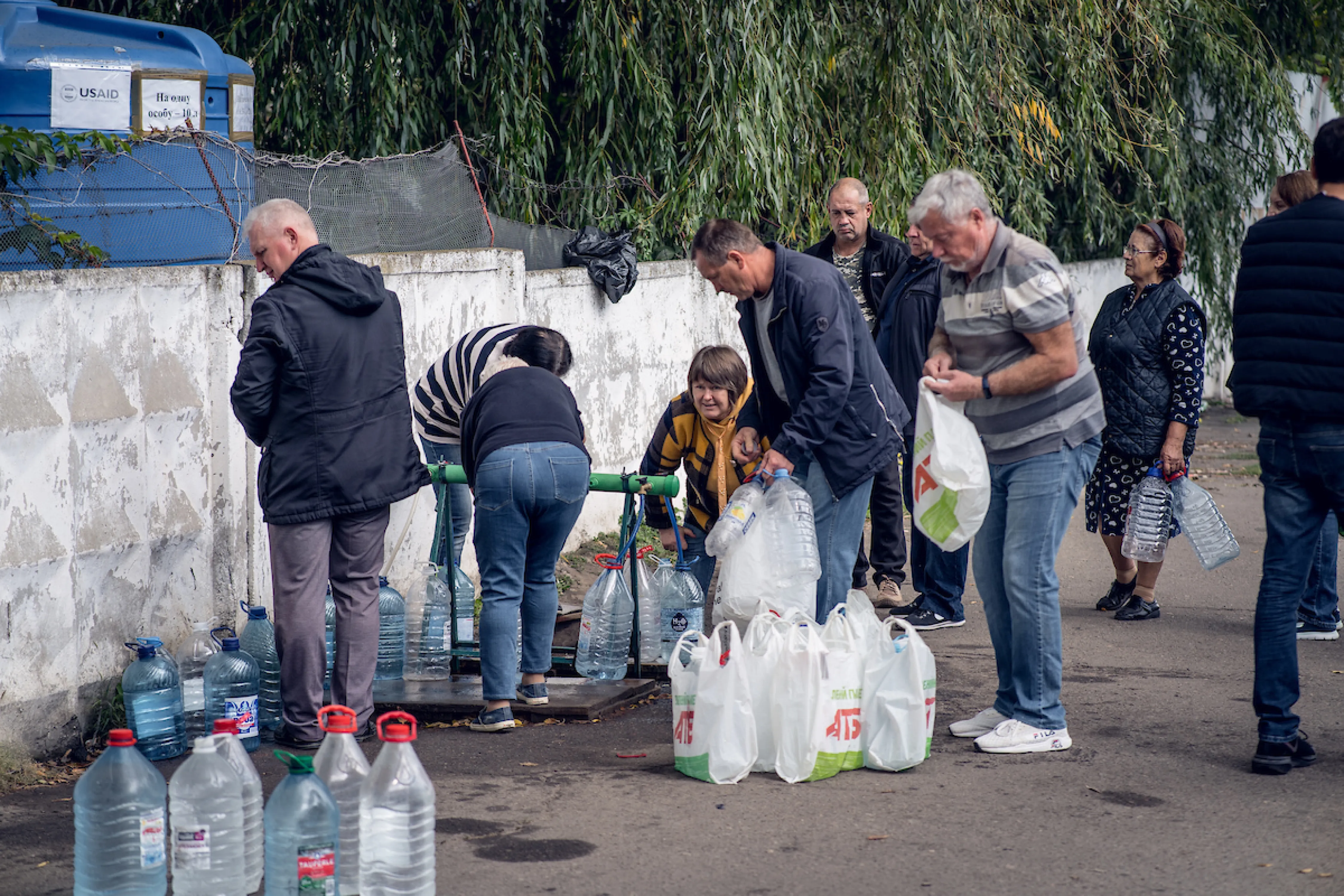 People collecting safe water at a tap stand