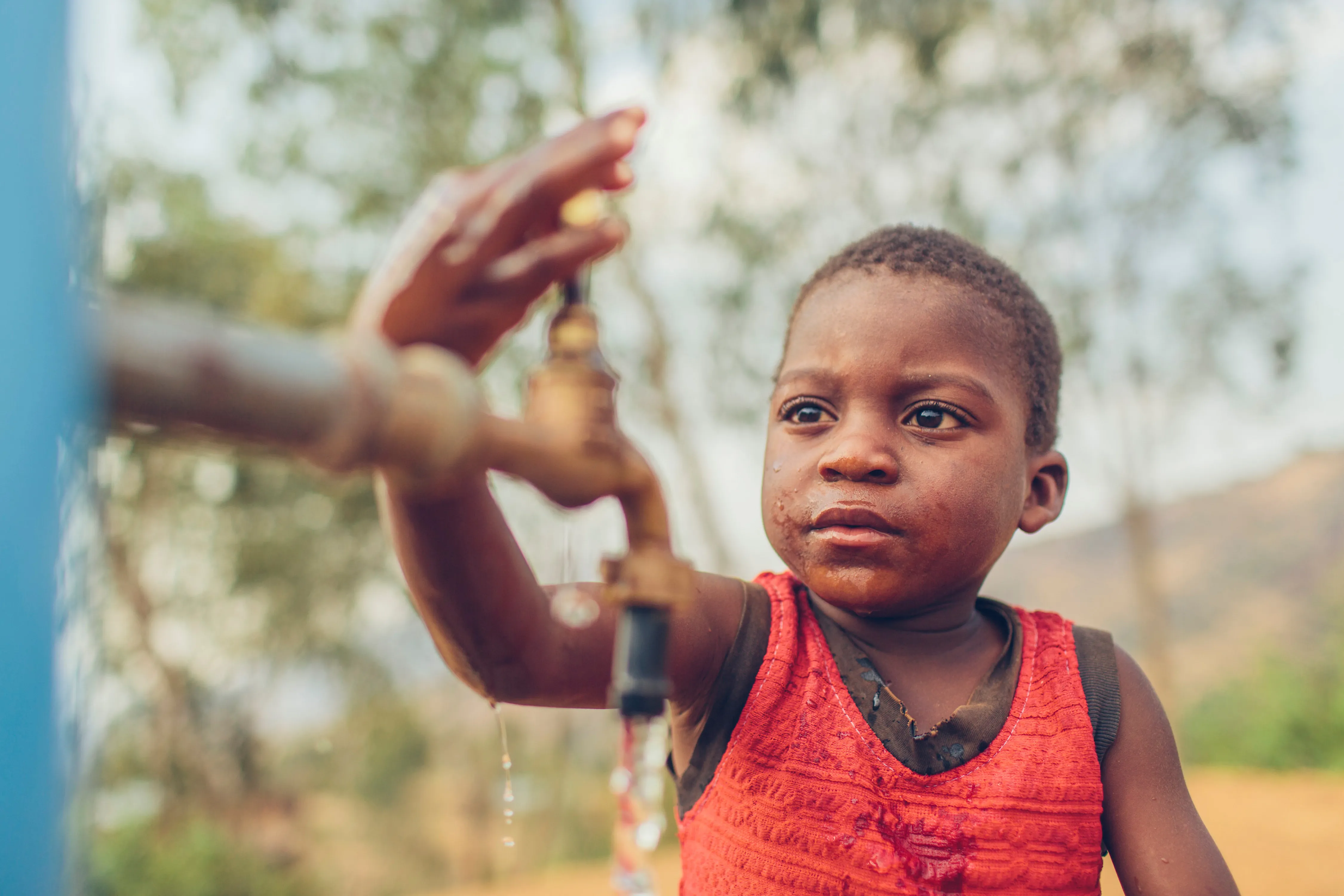 Boy opening tap stand