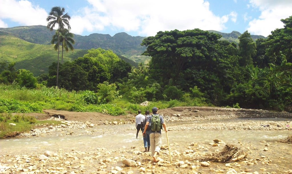 Brian and WMI Haiti team hike to assess a water source