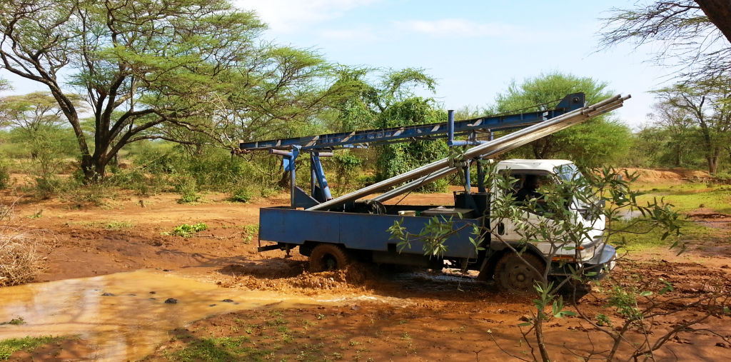 Truck with pump stuck in mud