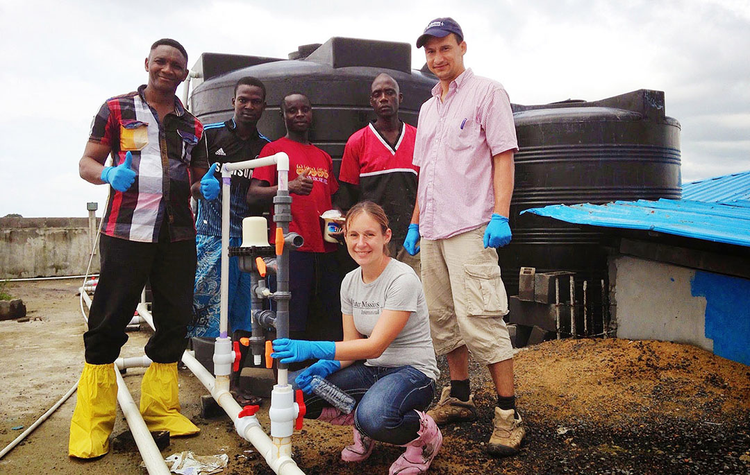 WMI Liberia team installing chlorinator at Island Clinic