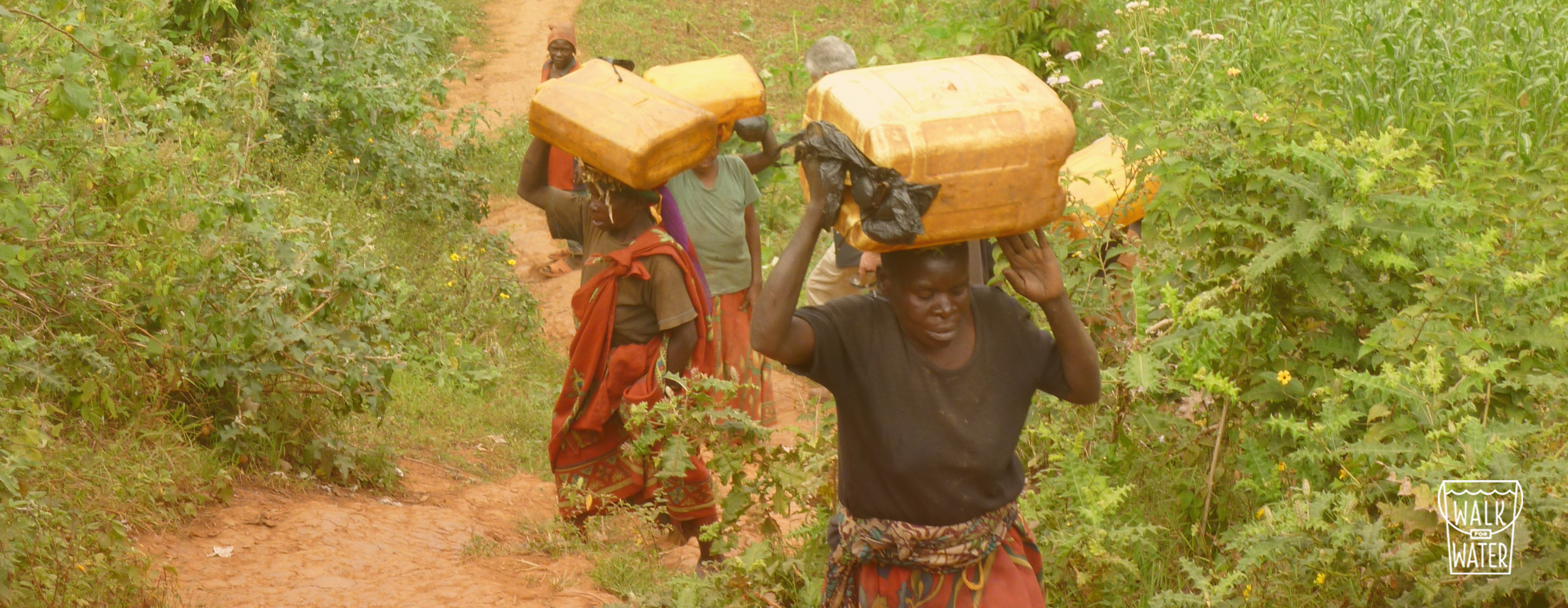 Women carrying jerry cans