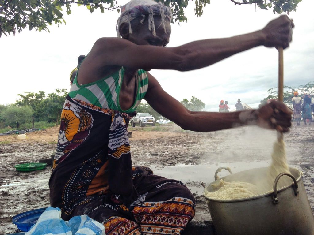 Woman in displacement camp cooks food