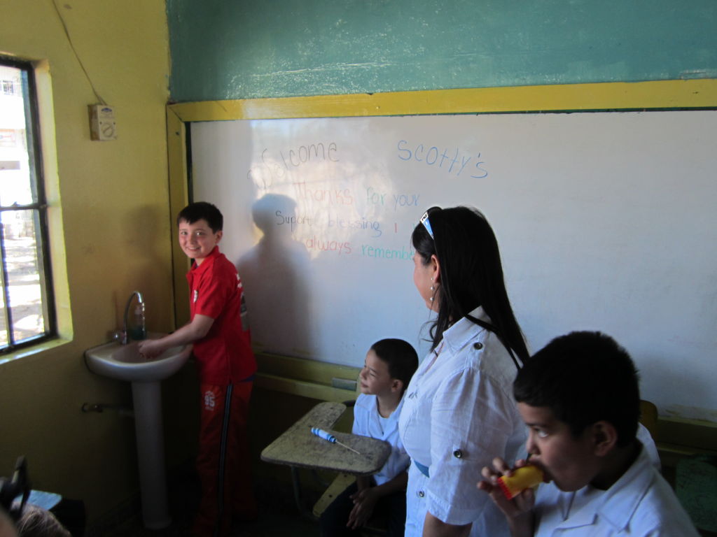 Scotty Parker washes his hands in a school with safe water in Honduras.