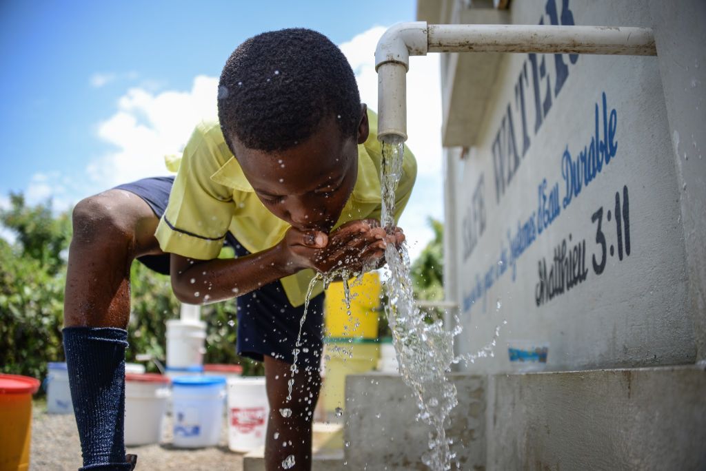 School boy drinks safe water at Bois Savanne kiosk