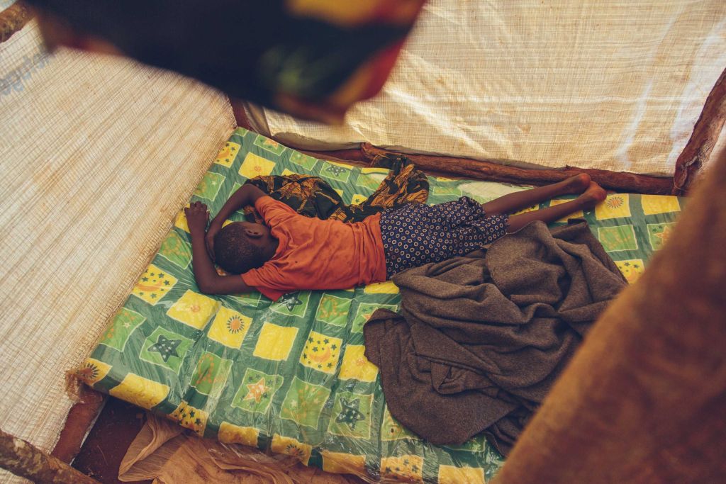 Child sleeping in bed.