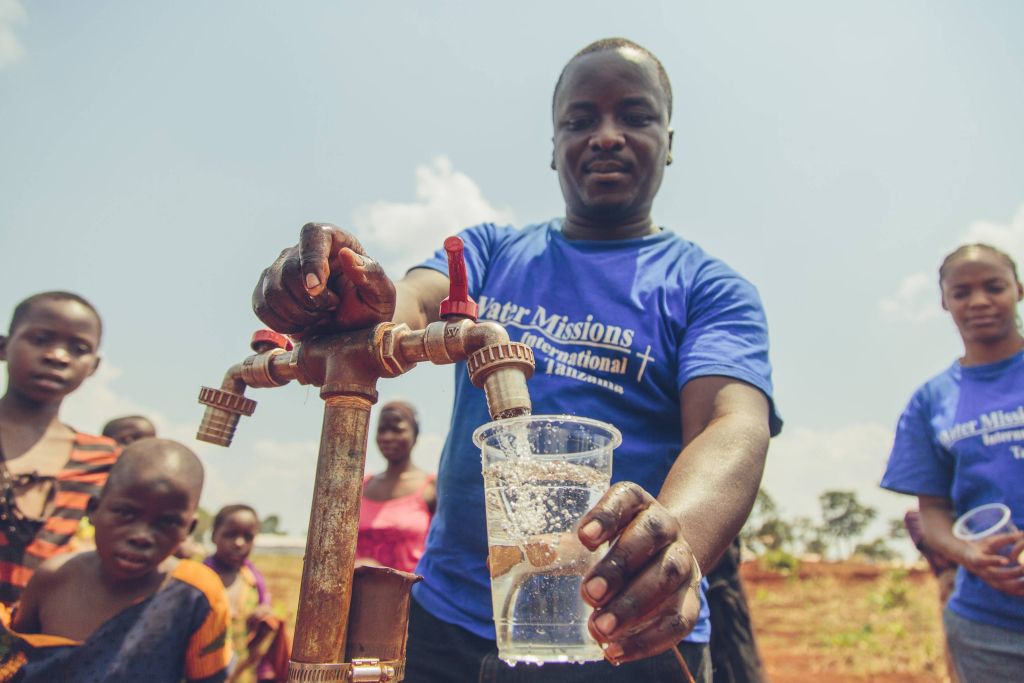 Water Mission staff with clean water.
