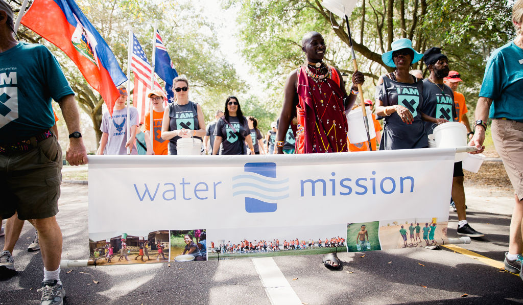 Founders George & Molly carry the Water Mission banner