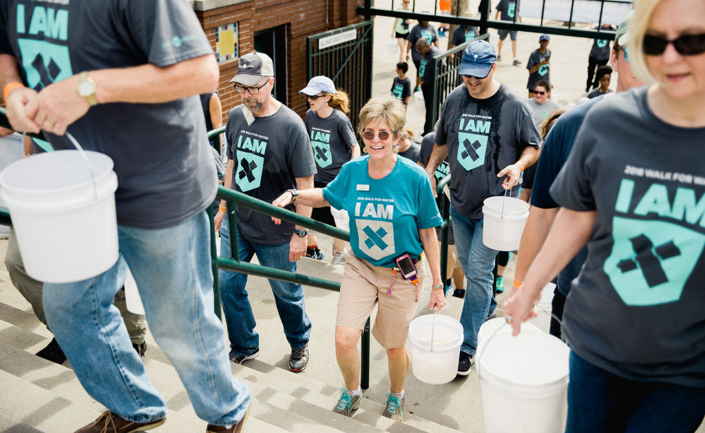 Founder Molly Greene carries bucket back into the Joseph P. Riley, Jr. Stadium, Charleston, SC