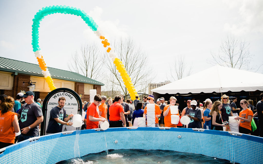 Walkers empty dirty water into a holding tank at the Charleston Walk for Water