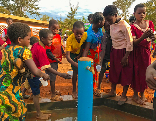 The Project Elev8 team celebrates safe water in Malawi.