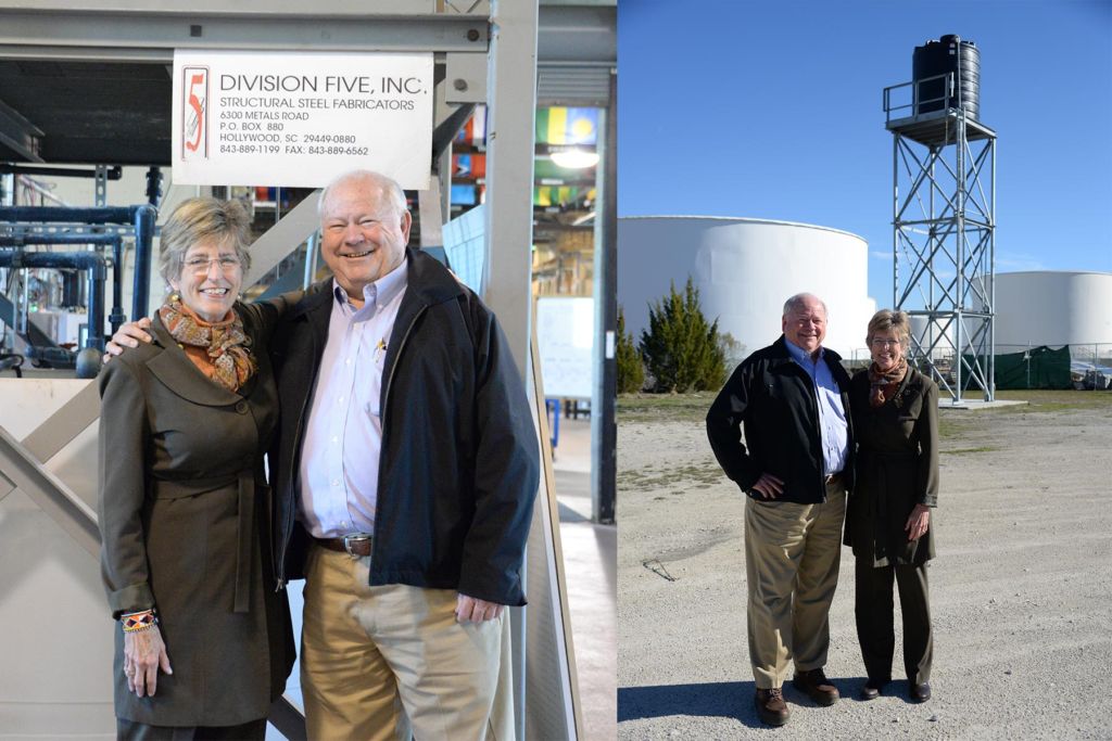 Roy Prescott and Molly Greene pose in front of the Division Five sign at Water Mission headquarters in North Charleston.