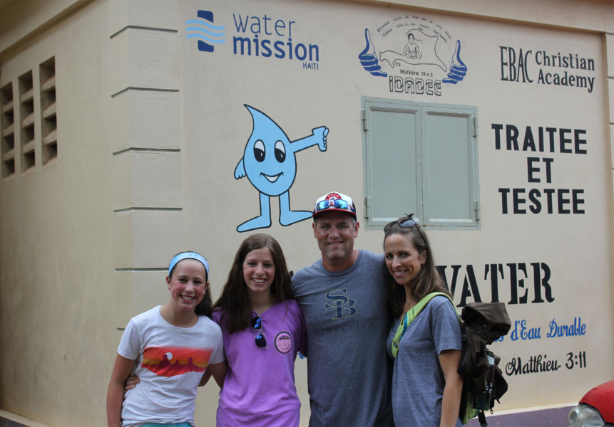 Lance, Cara, Hannah and Carly Berkman in front of the solar-powered water filtration system at EBAC orphanage and school in Cap Haitien, Haiti.