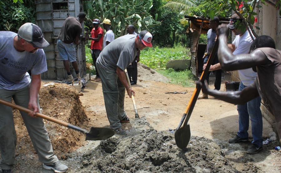 Scott Linebrink and Lance Berkman help build a latrine for a woman in Haiti.