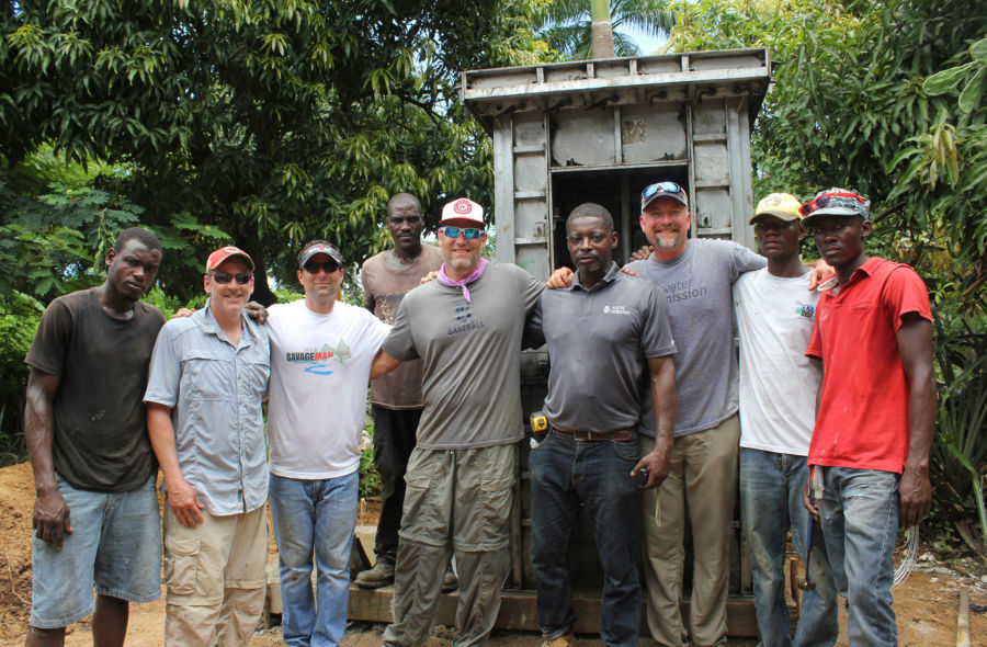 Lance Berkman, Scott Linebrink, Water Mission Haiti staff and others gather around latrine construction.