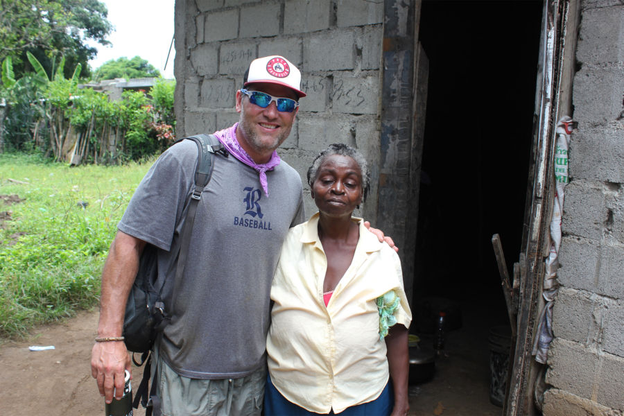 Lance Berkman with the woman who just received a new Healthy Latrine at her home in Bois Savanne.