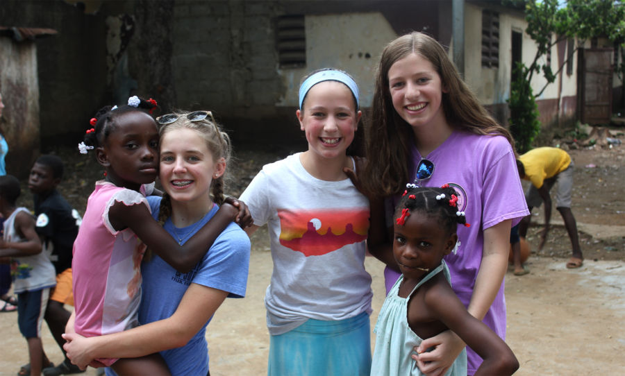 Berkman girls play with children at EBAC Orphanage in Haiti.