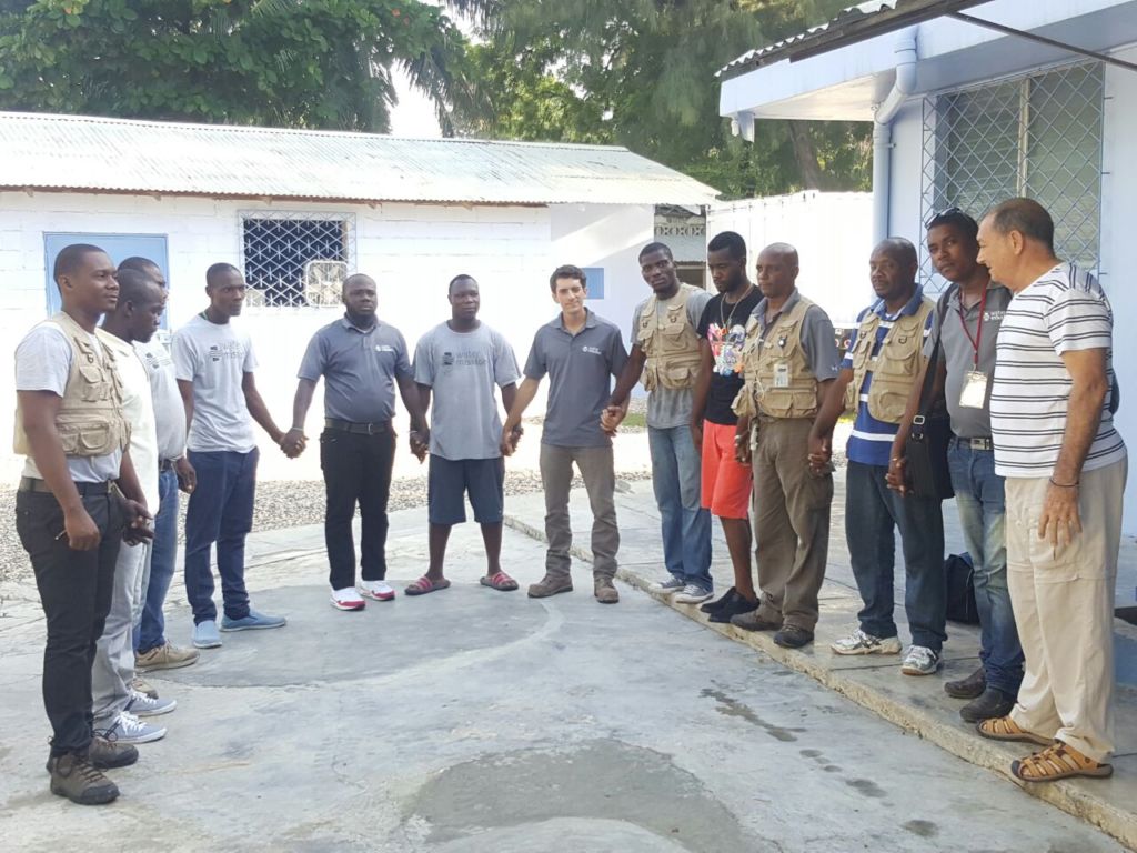 Water Mission Haiti staff pray before heading into communities.