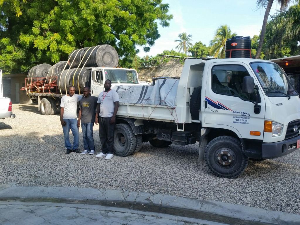 Water Mission Haiti staff load up water treatment systems onto trucks.
