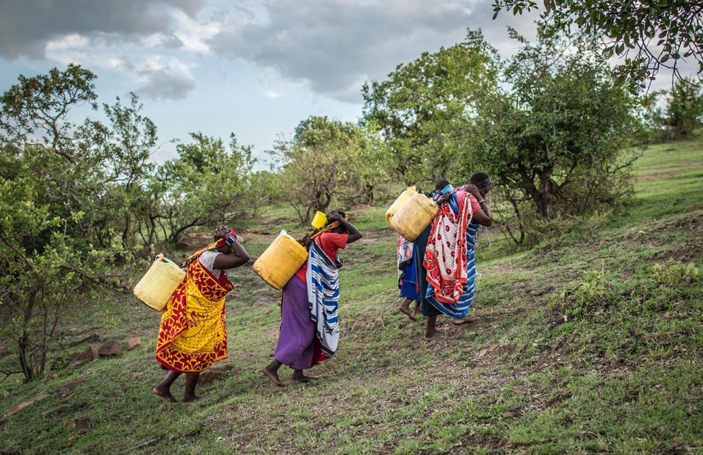 Women in Kenya walk for dirty water.