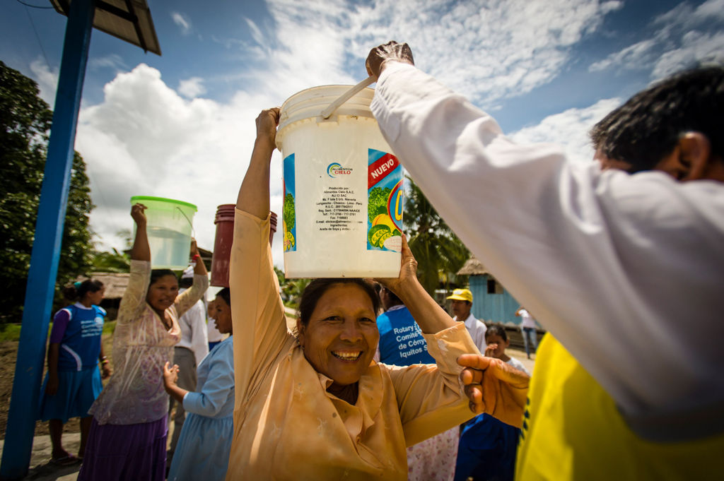 A woman in Peru smiles from receiving safe water.