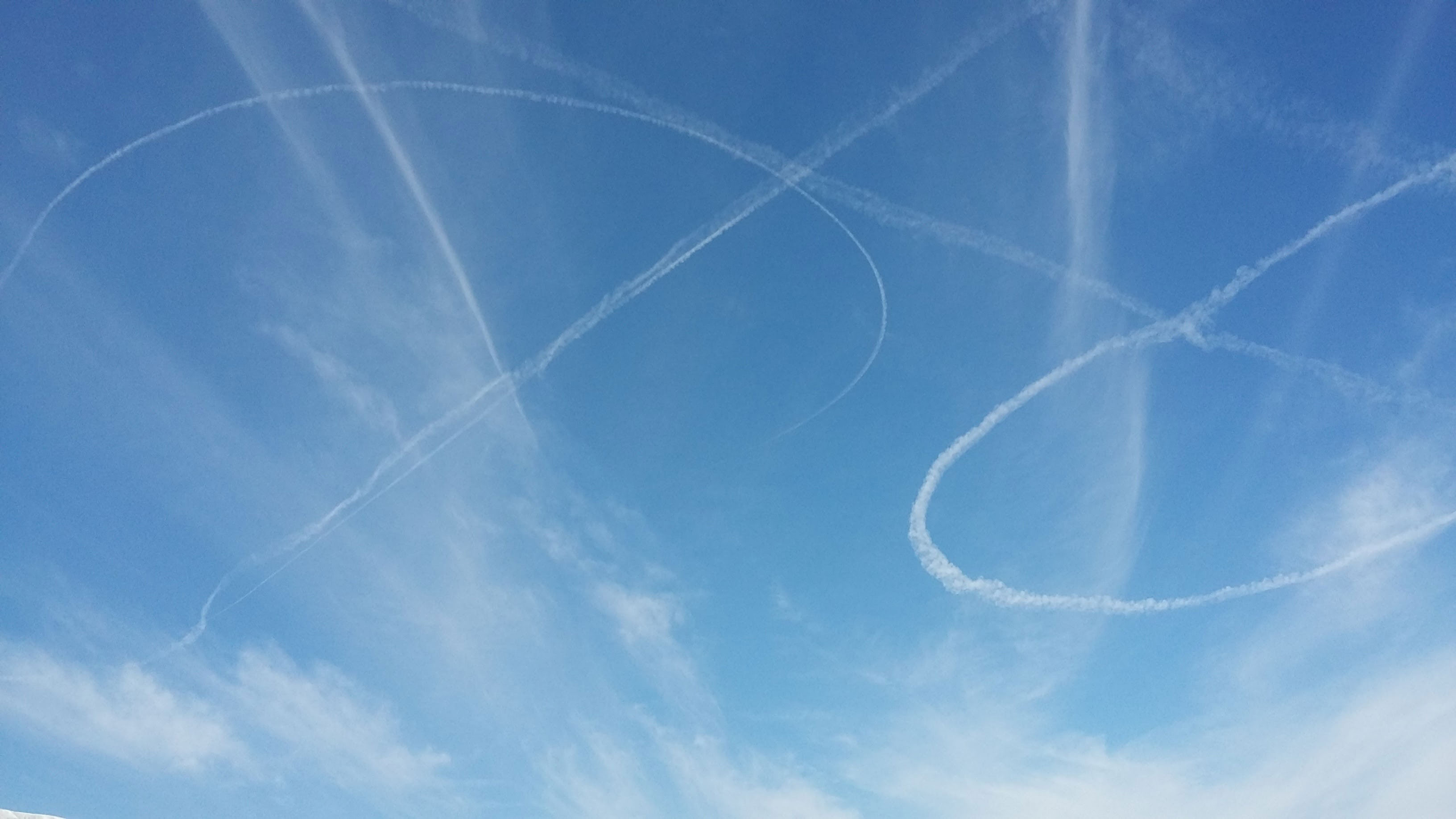 Bomber plans circle in the sky above.