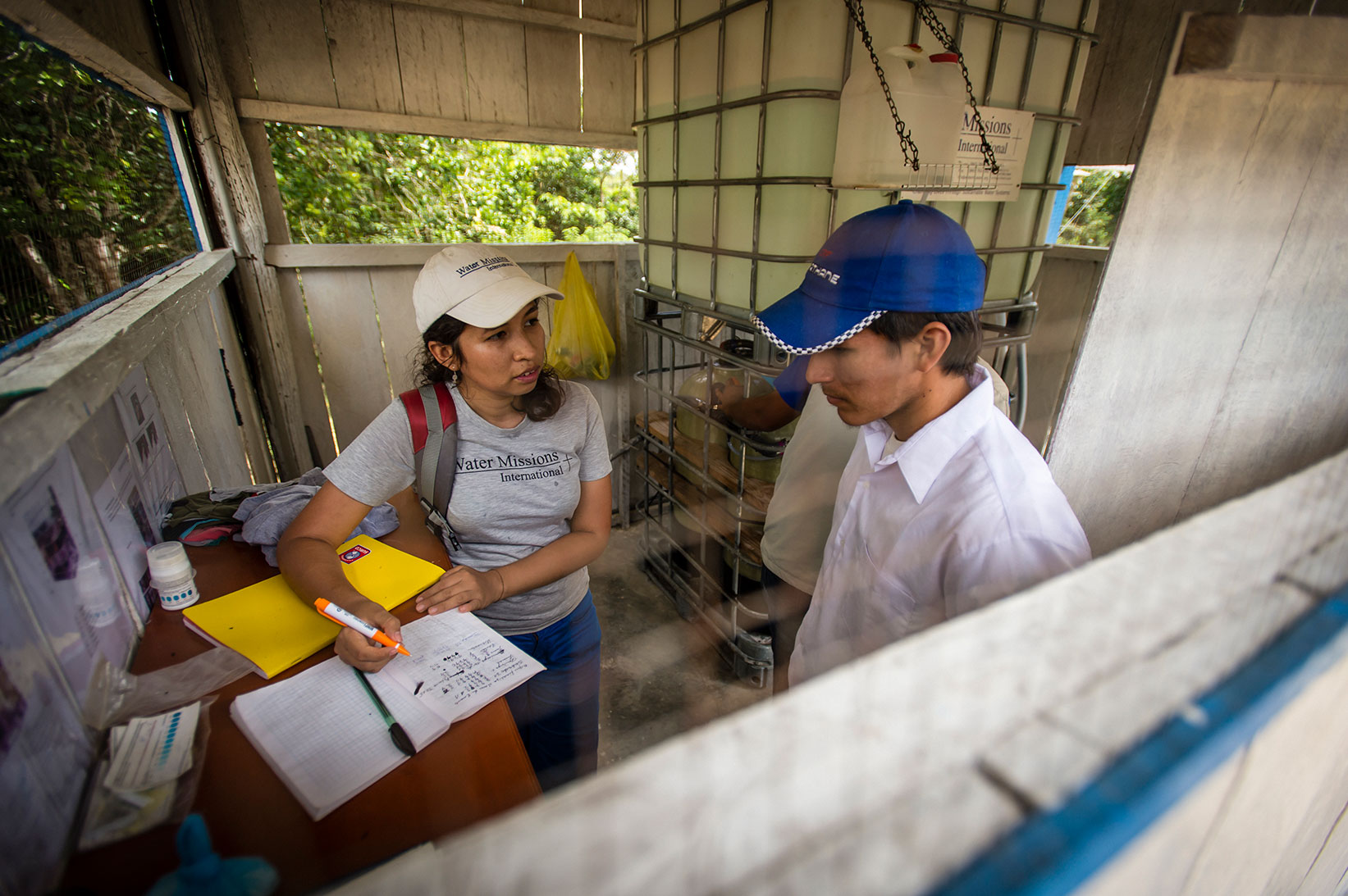 A Water Mission staff member teaches about sustainability.