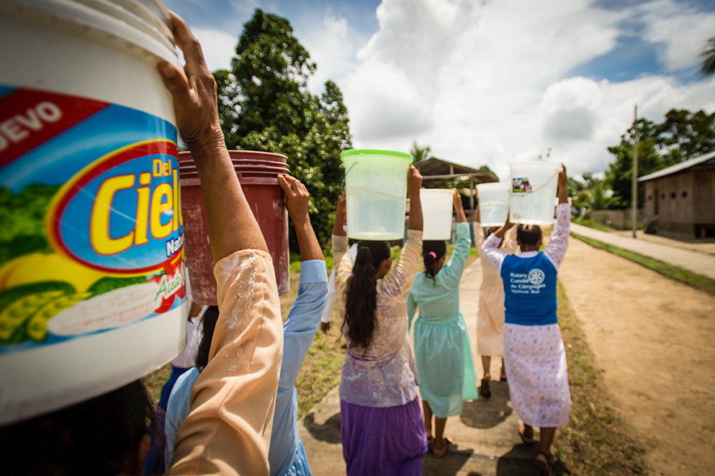 People collect safe water at a project in Peru.