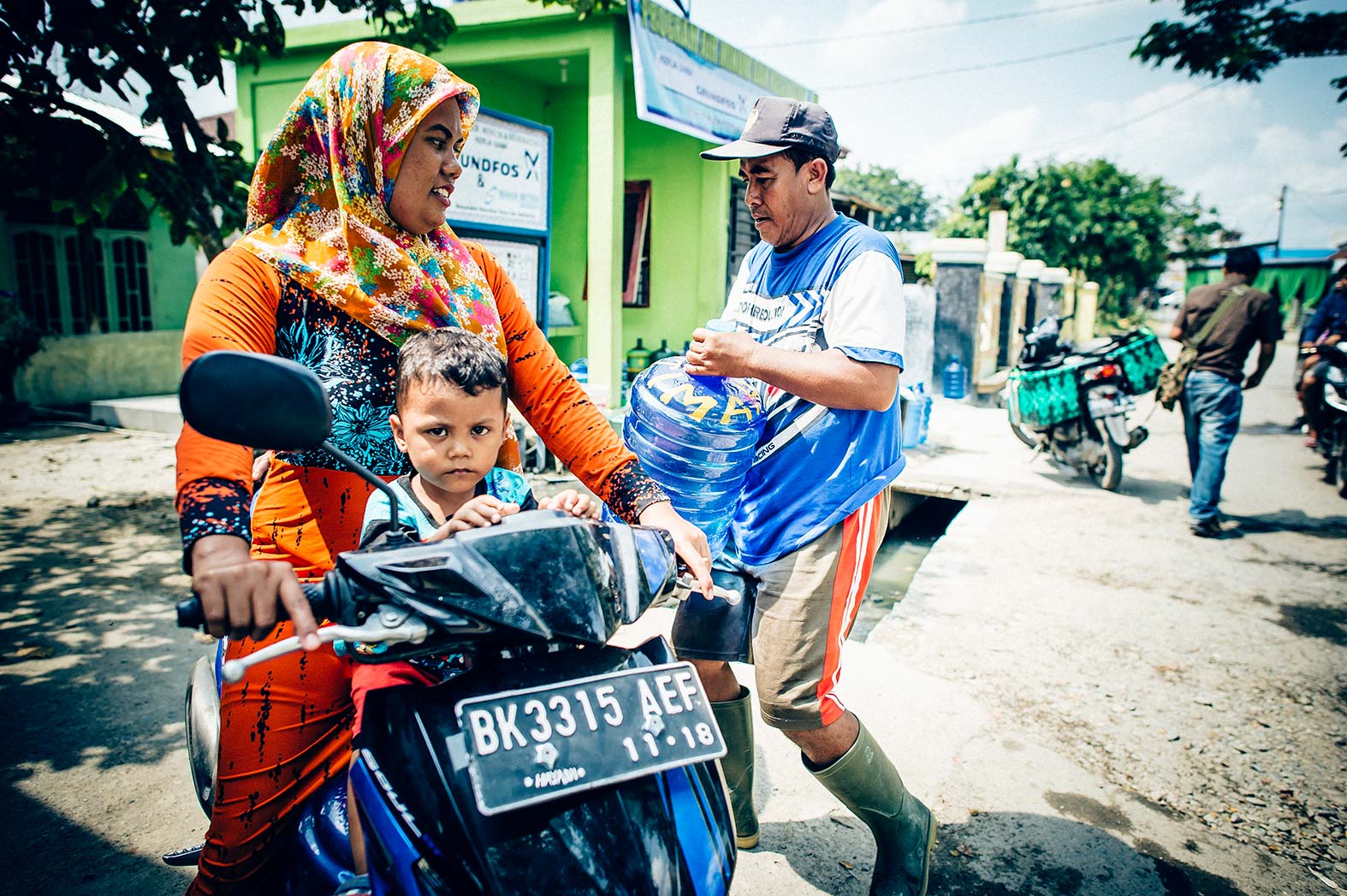 A mother collects safe water for her family in Indonesia.