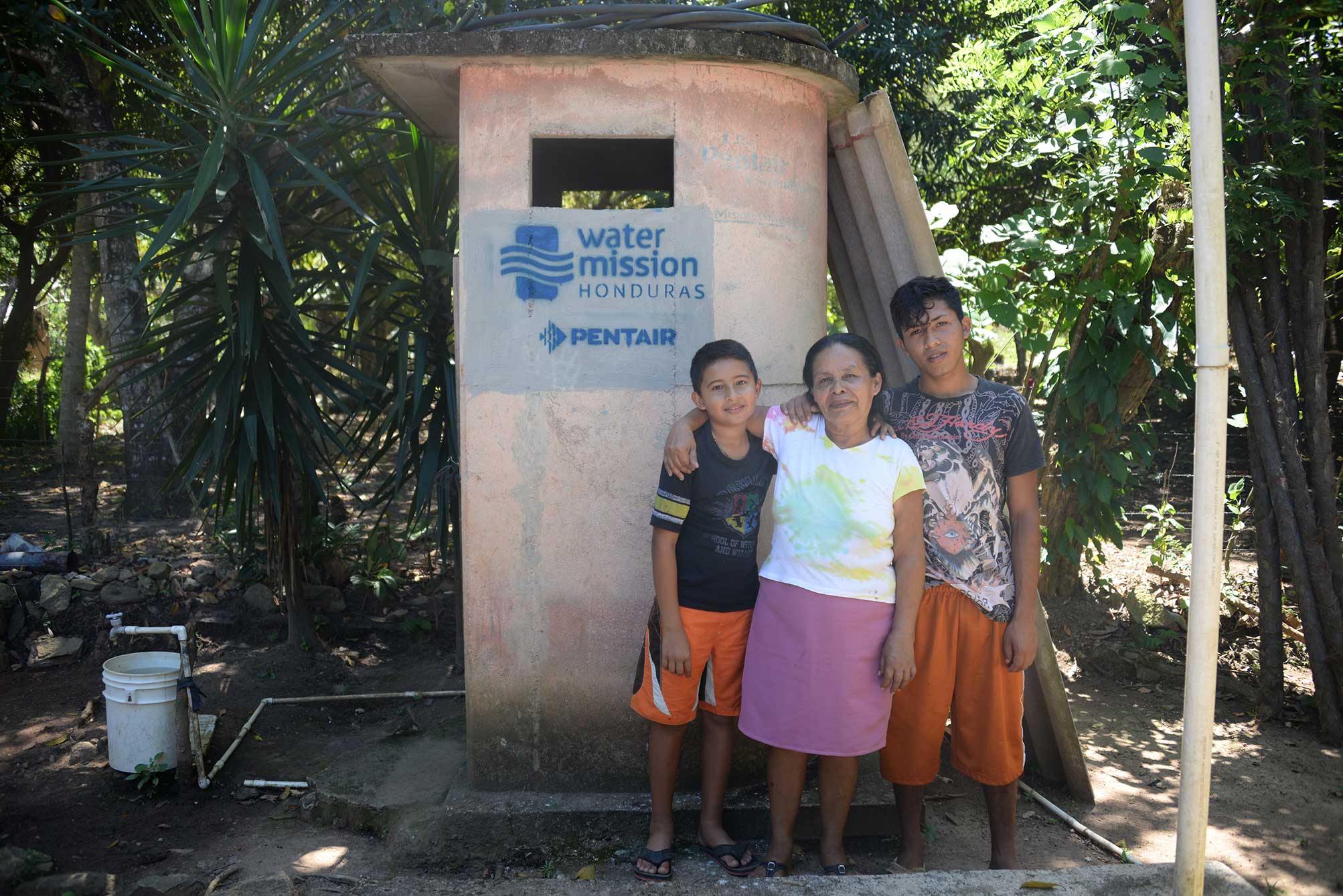 A family in Honduras enjoys their latrine installed by Water Mission and Pentair.