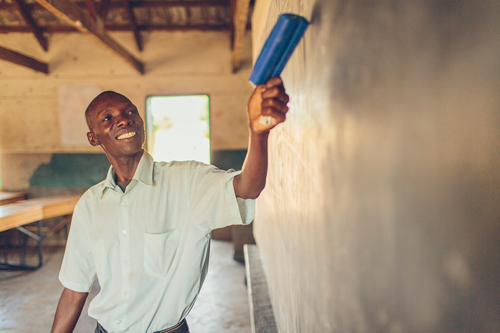 A teacher at Dina's school displays a lesson on the board.