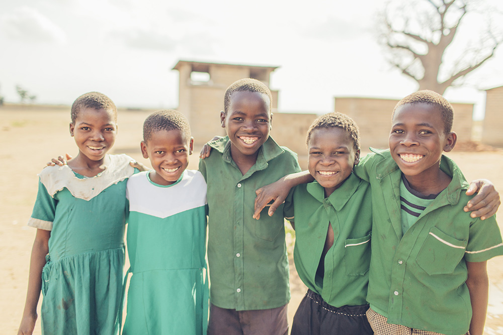 Dina and her classmates celebrate safe water flowing at their school.